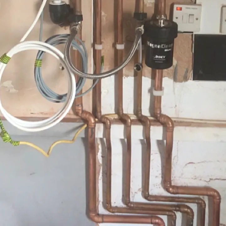 New copper pipework clipped along a wall