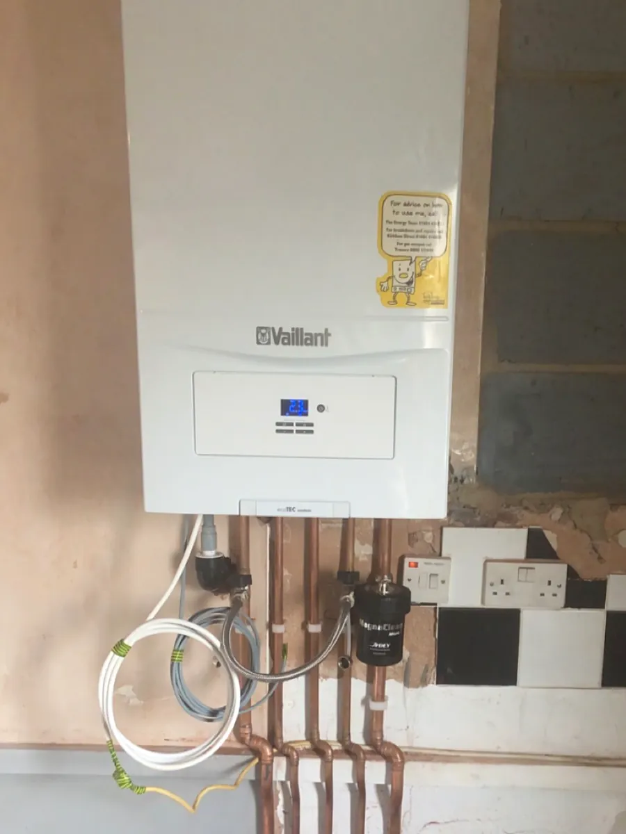 Wall-mounted Vaillant boiler above a run of new copper pipework