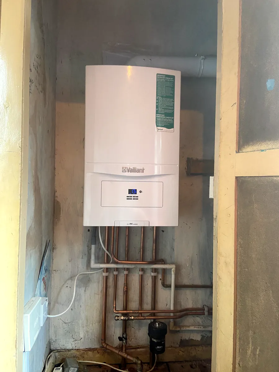 New boiler and pipework fitted in a utility space
